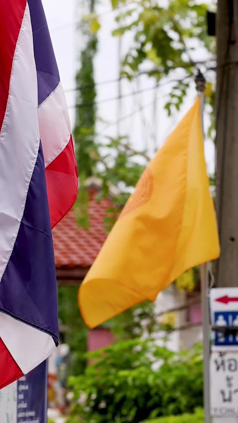 Thai National and Buddhist Flags Waving Outside a Traditional Temple Stock Footage 340179629