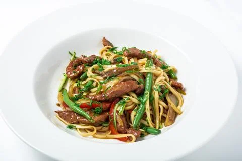 Thai noodles with ostrich meat, green beans and mushrooms. Stock Photos