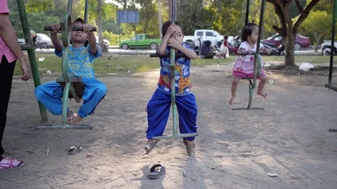 Thai not active children on the swing slowly enjoying swinging in the park Stock Footage 158033934