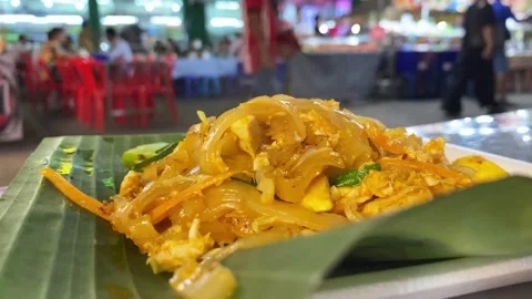 Thai Pad Thai noodle dish closeup street food stall authentic cuisine Stock Footage 331751173