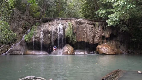 Thai People Play in a Cave Under A Waterfall Stock Footage 74292183