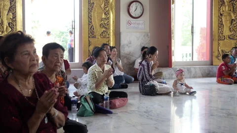 Thai people praying inside Buddhist temple, Cute little baby near mommy Stock Footage 161785675
