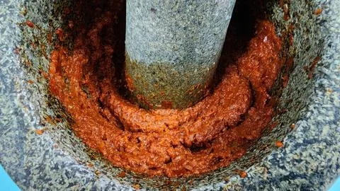Thai Red Curry Paste Hand-Pounded in Traditional Granite Mortar and Pestle Stock Photos