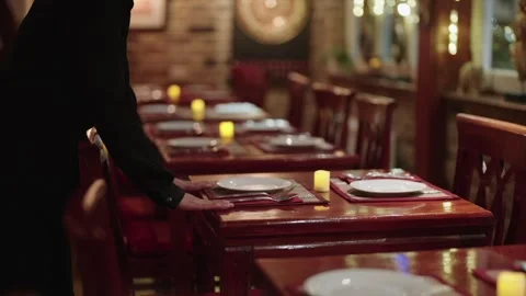 Thai Restaurant at Night with Waitress Setting Table near Window Handheld Shot. Stock-Footage 305632442