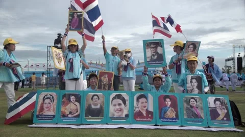 Thai royalists hold royal flags and portraits of Thai Queen Mother Sirikit Stock-Footage 314774137