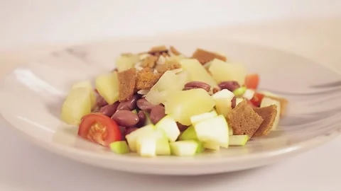 Thai salad with pineapple and croutons in a plate rotates in a circle Stock Footage 152091553