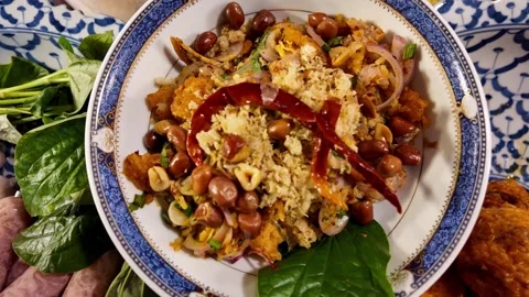 Thai Seafood Dish with Peanuts and Vegetables Served on a Plate Stock-Footage 342945600