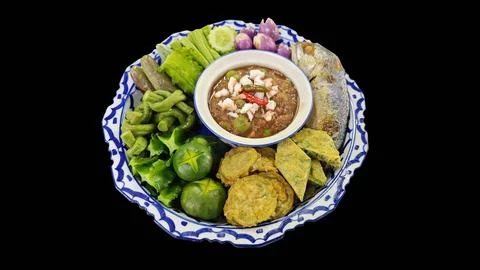 Thai shrimp paste dip with side dishes on black background. Stock Photos