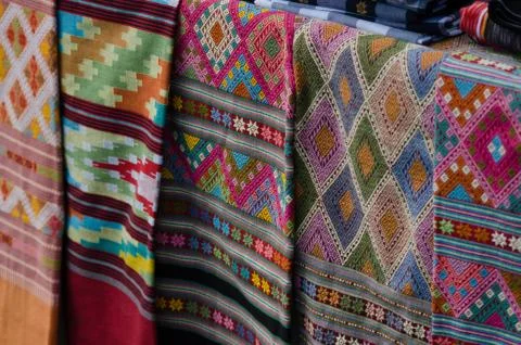 Thai silk is woven using ancient methods of weaving. No machinery Is the trad Stock Photos