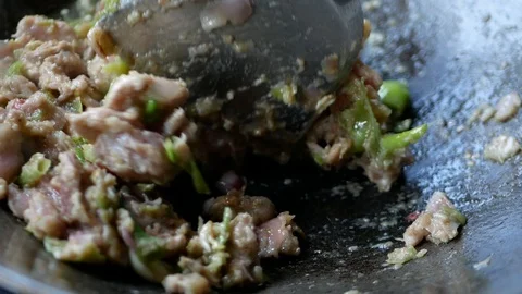 Thai spicy chili paste and pork being stir fried and cooked in a wok Stock Footage 103552275