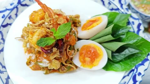 Thai spicy winged bean salad with shrimp and soft boiled egg. Stock Footage 342394518