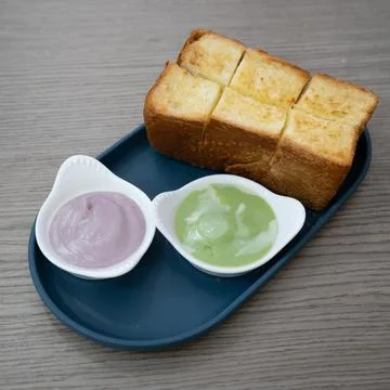 Thai Steamed Bread with Pandan or Taro Sweet Dip Stock Photos