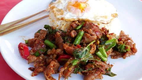 Thai Stir-Fried meet with Red Curry Paste Served Over Rice with Fried Egg Stock Footage 346674228