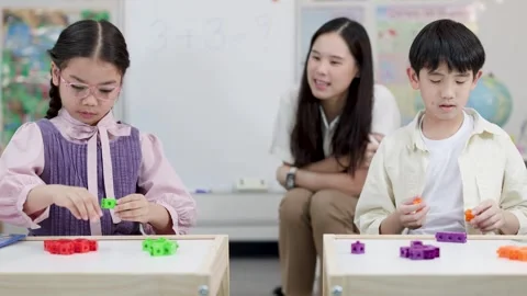 Thai Students and Teacher Learning Math with Colorful Counting Blocks Stock Footage 334172229