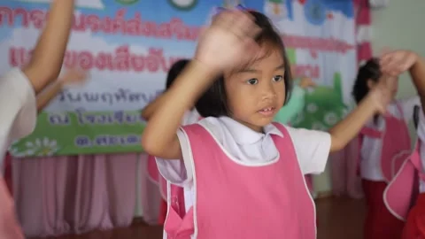 Thai students dancing activity cute kindergarten kids happy waving their hands Stock Footage 156755726