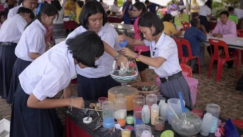 Thai students making design cactus succulent terrarium with color sand art Stock Footage 156754330