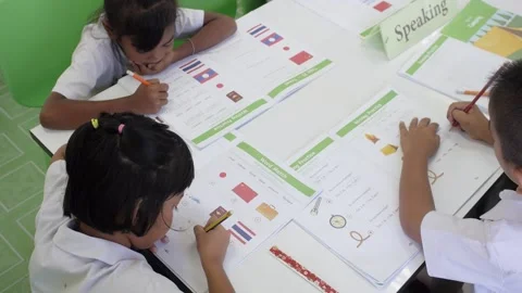 Thai students study English language in classroom writing lesson on test book Stock Footage 156762597
