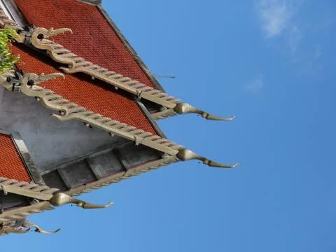 Thai style roof with beautiful sky. Stock Photos