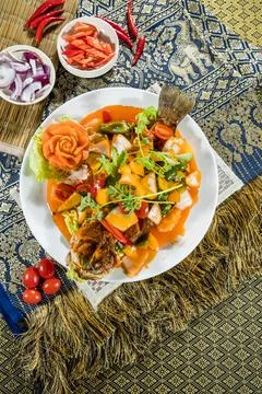 Thai sweet sour fish bell pepper tomato onion garnish Stock Photos