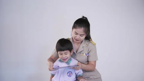 Thai teacher in official uniform teaching an elementary student Video stock 150301367