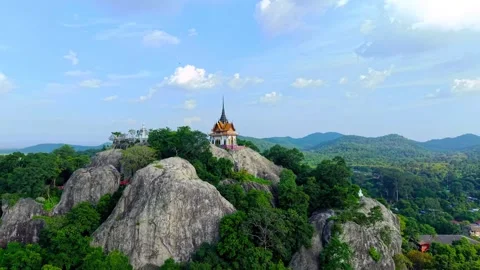 Thai temple on rocky mountain peak at Khao No in Nakhon Sawan with cinematic Stock Footage 343696520