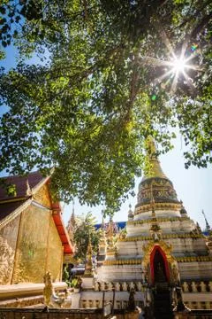 Thai temple with tree and sunlight Stock Photos