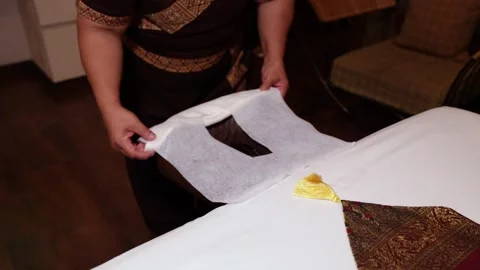 Thai Therapist Prepares Massage Table with Flower Stock Footage 297370828