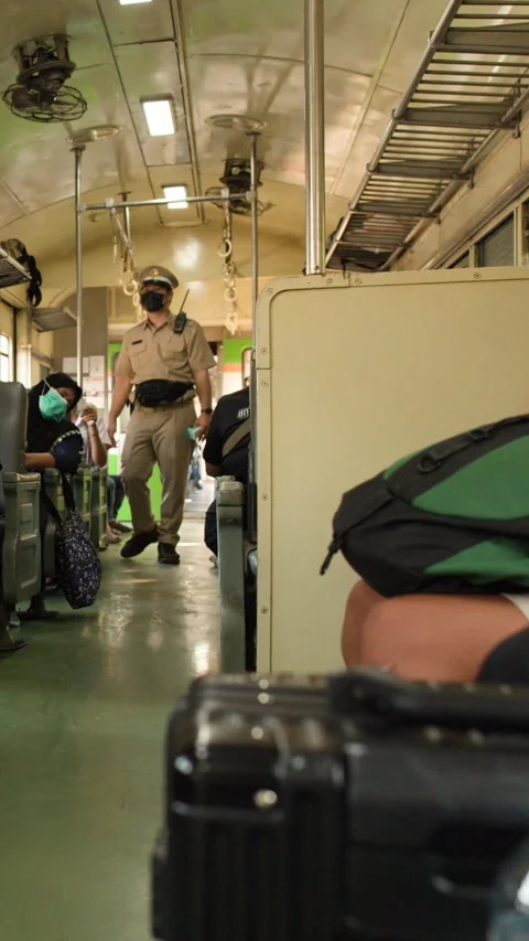 Thai Train Conductor Checking Tickets of Passengers on a Commuter Train Stock Footage 327447778