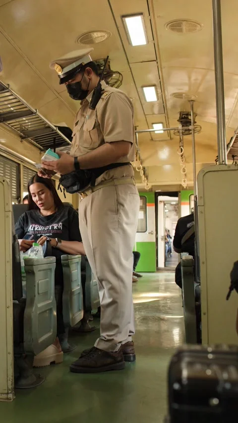 Thai Train Conductor Checking Tickets of Passengers on Commuter Train Stock Footage 327711055