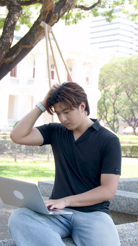 Thai University Student Using Laptop Outdoors on Campus Park Bench Stock Footage 336352258