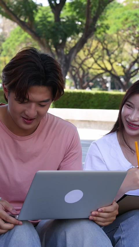Thai University Students Studying Together Outdoors with Laptop and Tablet Stock Footage 329010806