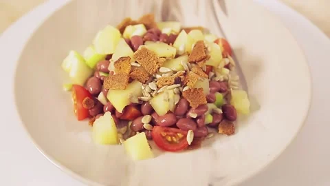 Thai vegetable salad with pineapple and croutons in a plate rotates in a circle Stock Footage 151606181