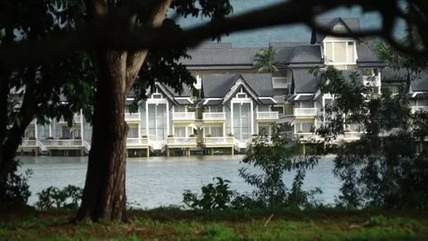 Thai Villas on a water through trees Stock Footage 72395518