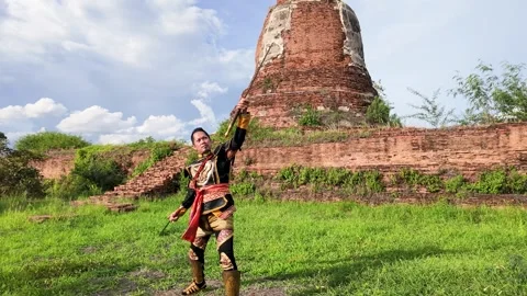 Thai Warrior in Ancient Armor Holding Sword at Ayutthaya Ruins Stock Footage 344724981