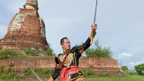 Thai Warrior in Ancient Armor Performing Sword Martial Arts at Temple Ruins Stock Footage 341075811
