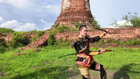 Thai Warrior in Ancient Armor Practicing Sword Fighting at Ayutthaya Ruins Stock Footage 344725005