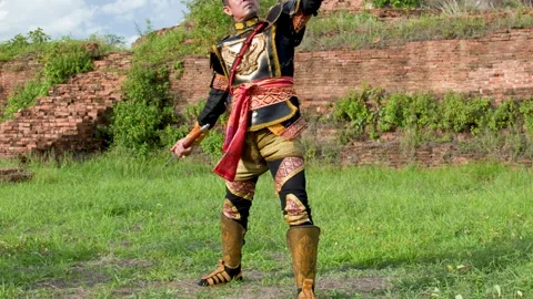 Thai Warrior in Ancient Armor Training with Sword at Historical Ruins Stock Footage 338319650