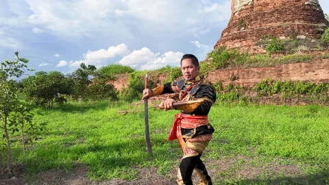Thai Warrior in Ancient Armor Training with Swords at Ayutthaya Ruins Stock Footage 343808117