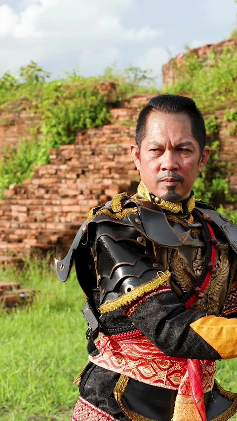 Thai Warrior Performing Martial Arts with Swords at Ancient Ruins Stock Footage 339870194