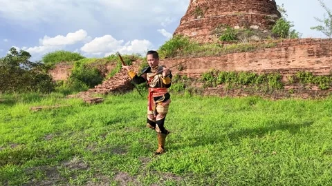 Thai Warrior Practicing Sword Combat at Ancient Ayutthaya Temple Ruins Stock Footage 344725027