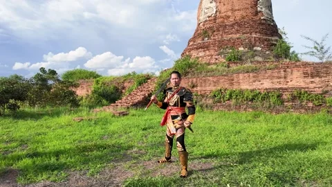 Thai Warrior in Traditional Armor Standing at Ayutthaya Temple Ruins Stock Footage 344725125