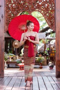 Thai woman dressed in traditional Northern Thailand culture costume holding.. Stock Photos