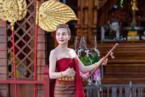 Thai woman dressed in traditional Northern Thailand culture costume with Th.. Stock Photos