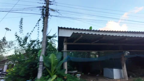 Thailand - August 15, 2026 - Roadside landscape with local housing and elec.. Stock Footage 342332983