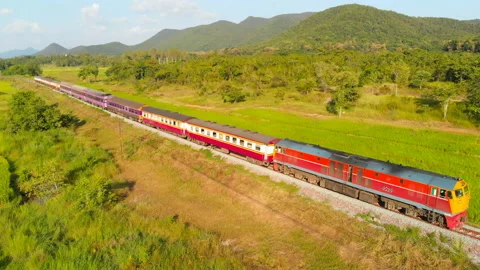 Thailand train run pass through green rice fields Stock Footage 155668337