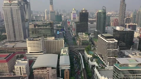 Thailand Train snaking through downtown Bangkok buildings  Stock Footage 293642123