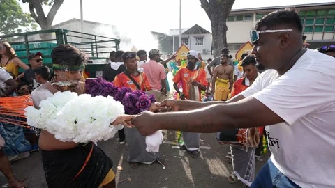 Thaipusam piercing devotional ritual kavadi procession with hooked skewers Stock Footage 332738852