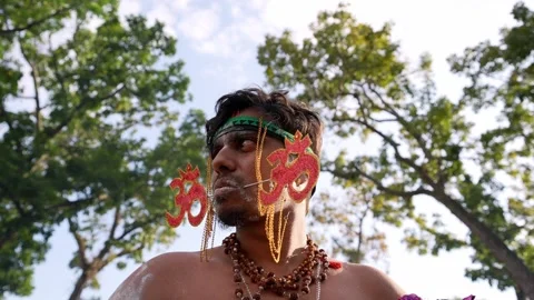 Thaipusam piercing ritual devotional procession with facial skewers Stock Footage 332736973