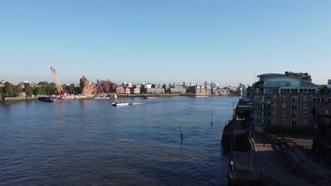 Thames Clipper boat on River Thames with East London skyline - Drone footage Stock Footage 287769478
