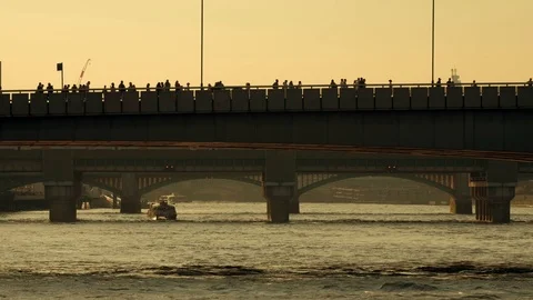 Thames Clipper riverbus passes under London Bridges at sunset Stock Footage 109113292